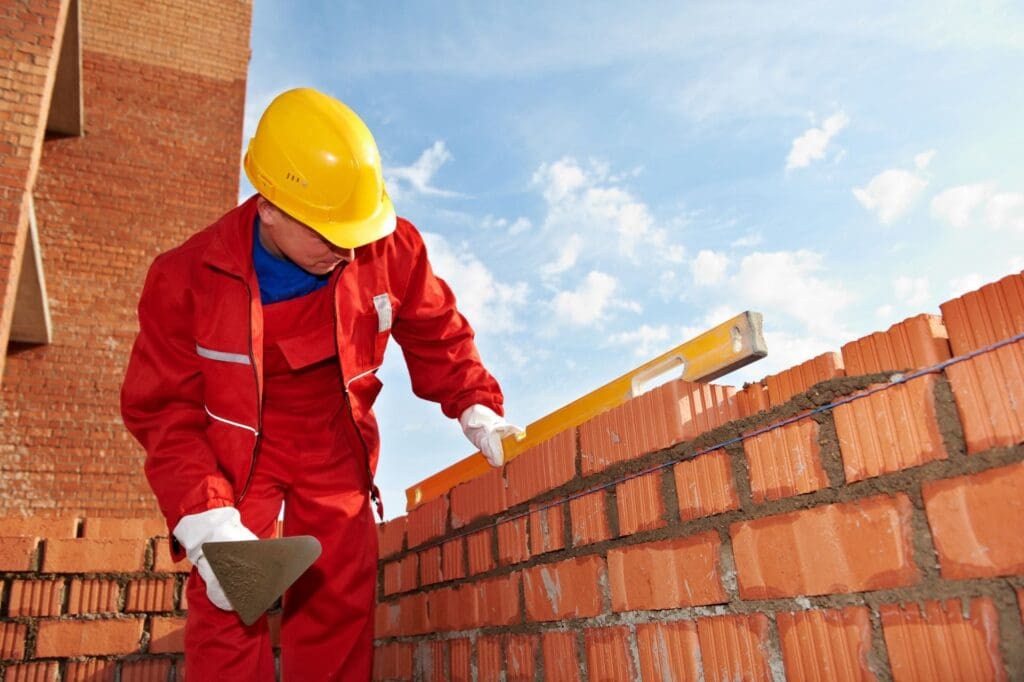 Highland Masonry worker laying bricks
